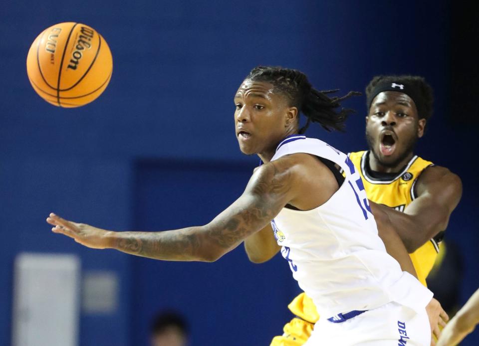 Delaware's Jyare Davis (left) gets a turnover against Towson's Charles Thompson in the first half of Delaware's 67-56 loss at the Bob Carpenter Center, Saturday, Jan. 27, 2024.