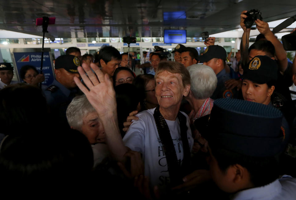 Australian Roman Catholic nun Sister Patricia Fox waves to supporters as she is escorted to the Ninoy Aquino International Airport for her flight to Australia Saturday, Nov. 3, 2018, in Manila, Philippines. Sister Fox decided to leave after 27 years in the country after the Immigration Bureau denied her application for the extension of her visa. Sr. Fox called on Filipinos to unite and fight human rights abuses ahead of her forced departure from the country. (AP Photo/Bullit Marquez)