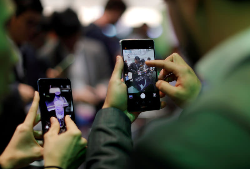 FILE PHOTO: Visitors try Huawei's devices during Mobile World Congress in Barcelona, Spain, February 27, 2017. REUTERS/Eric Gaillard/File Photo