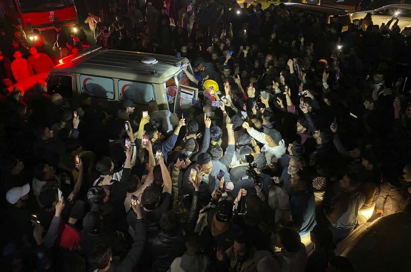 Iraqis gather at the site of a burned vehicle targeted by a US drone strike in east Baghdad.