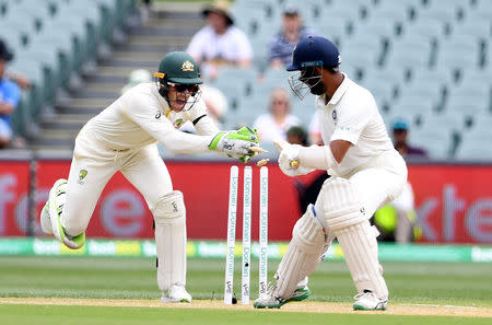 Austalia's wicketkeeper Tim Paine attempts to stump India's Cheteshwar Pujara on day four of the first test match between Australia and India at the Adelaide Oval in Adelaide, Australia, December 9, 2018. AAP/Dave Hunt/via REUTERS