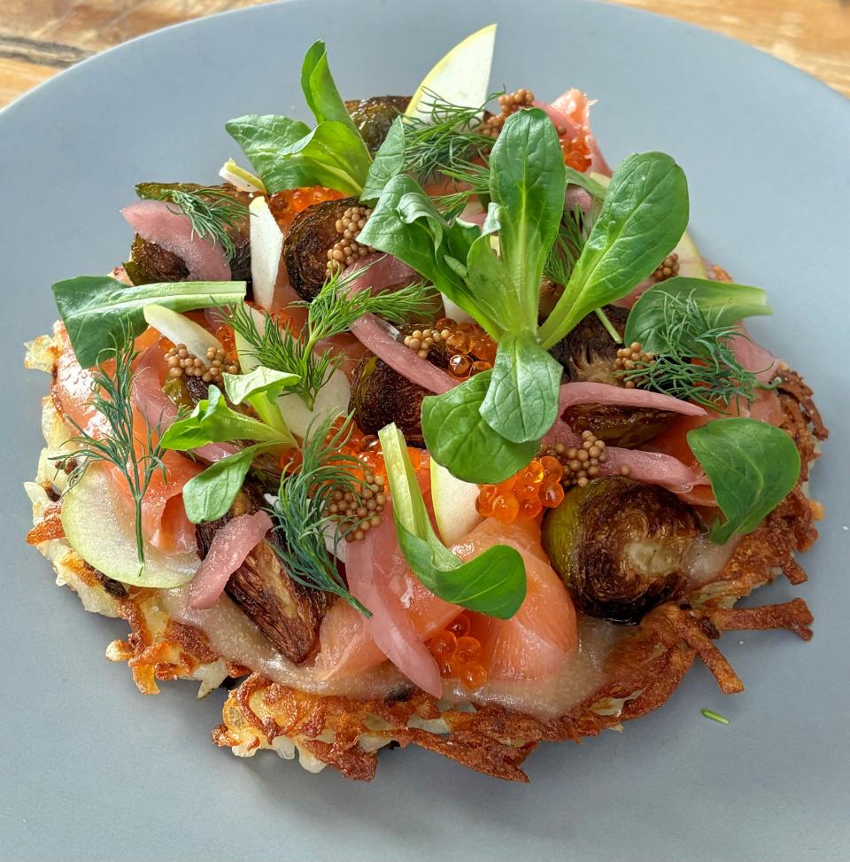 Crispy potato latkes with smoked salmon, roasted Brussels sprouts, pickled mustard seeds, creme fraiche, apple butter and mustard greens for brunch at Juniper Hill in the Annandale section of Clinton.