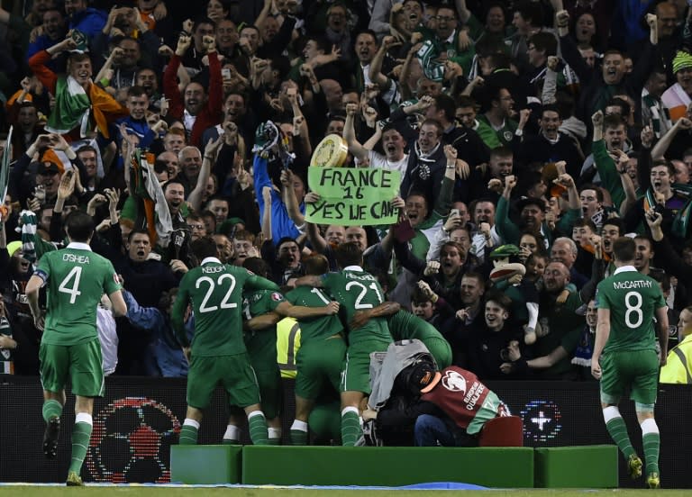 Ireland's Shane Long celebrates with teammates after scoring a goal during their UEFA Euro 2016 Group D qualifying match against Germany, at the Aviva stadium in Dublin, on October 8, 2015