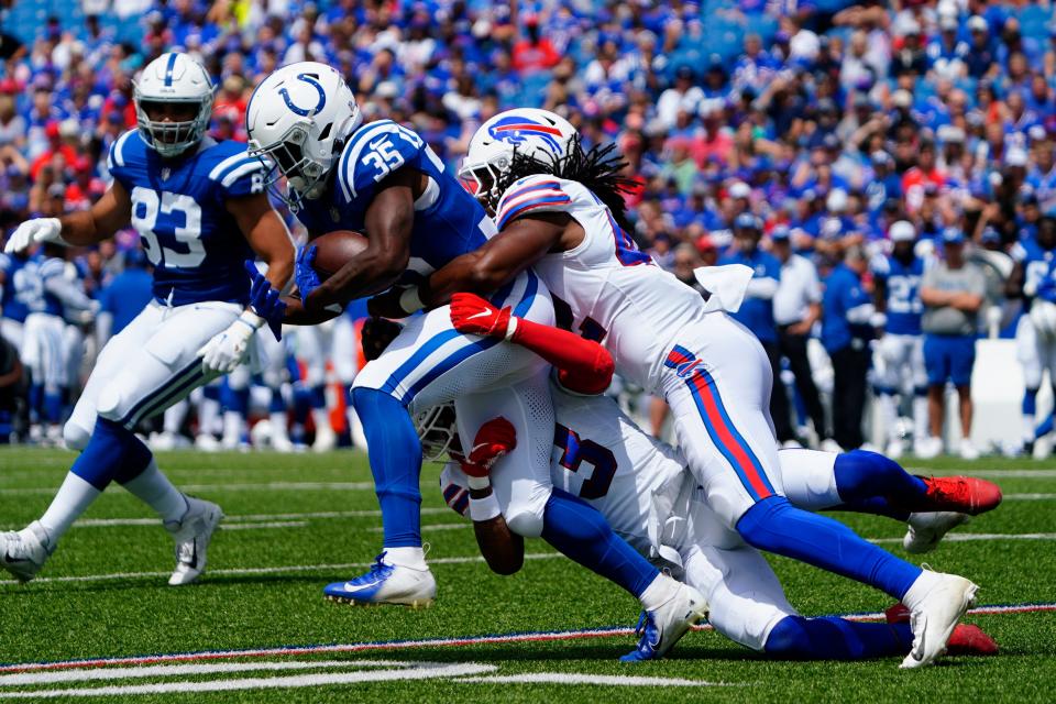 Buffalo Bills safety Damar Hamlin and linebacker Dorian Williams tackle Indianapolis Colts running back Deon Jackson during the first half at Highmark Stadium.