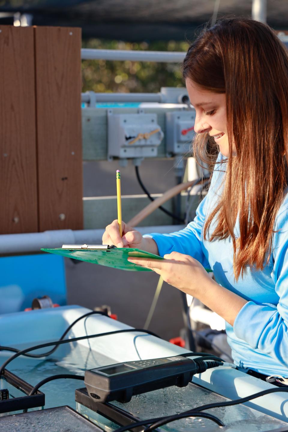 Mote Coral Resilience Staff Biologist Chelsea Petrik monitors Mote's Climate and Acidification Ocean Simulator (CAOS) in the Florida Keys. The system, housed at Mote's Elizabeth Moore International Center for Coral Reef Research & Restoration (IC2R3), is designed to test how climate change, including ocean acidification and warming temperatures, impact corals.