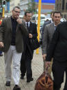 Oscar Pistorius, second from left, arrives at the high court in Pretoria, South Africa, Monday, March 10, 2014. The testimony in the first week of Pistorius' murder trial was jaw dropping at times, and more riveting evidence is expected as the prosecution seeks to prove beyond reasonable doubt that the double-amputee athlete intentionally shot dead his girlfriend Reeva Steenkamp, on Valentines Day in 2013. (AP Photo/Themba Hadebe)