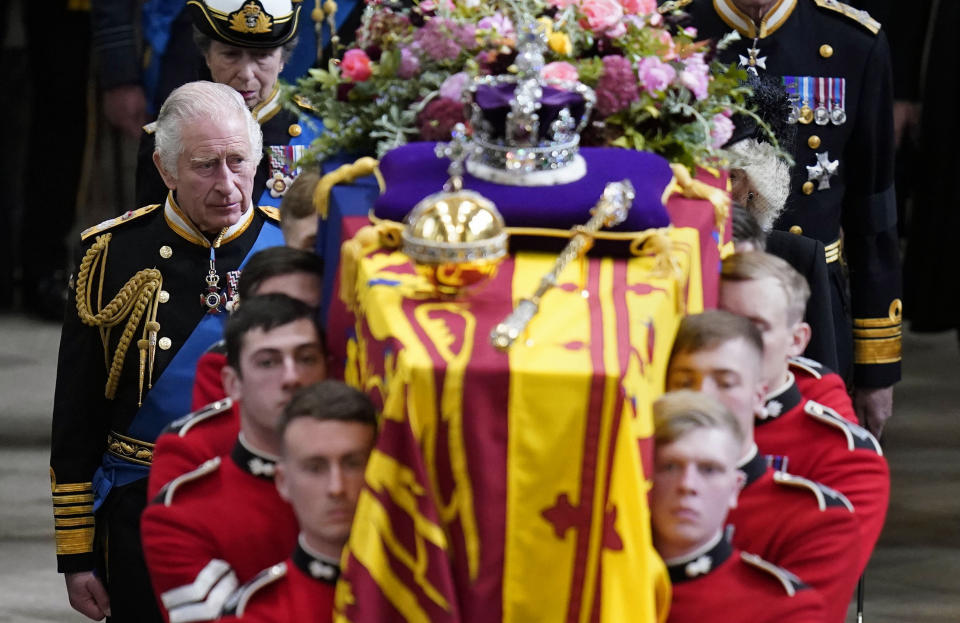 FILE - King Charles III and members of the Royal family follow behind the coffin of Queen Elizabeth II, draped in the Royal Standard with the Imperial State Crown and the Sovereign's orb and sceptre, as it is carried out of Westminster Abbey after her State Funeral, in London, Monday Sept. 19, 2022. King Charles III faces the task of preserving a 1,000-year-old monarchy that his mother nurtured for seven decades but that faces an uncertain future. The challenge is immense. (Danny Lawson/Pool Photo via AP, File)