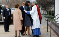 The checkered, collarless coat fits Obama perfectly with a cinched-in waist and a flare at the hips. It goes great with her new blunt bangs. (AP Photo/Jacquelyn Martin)