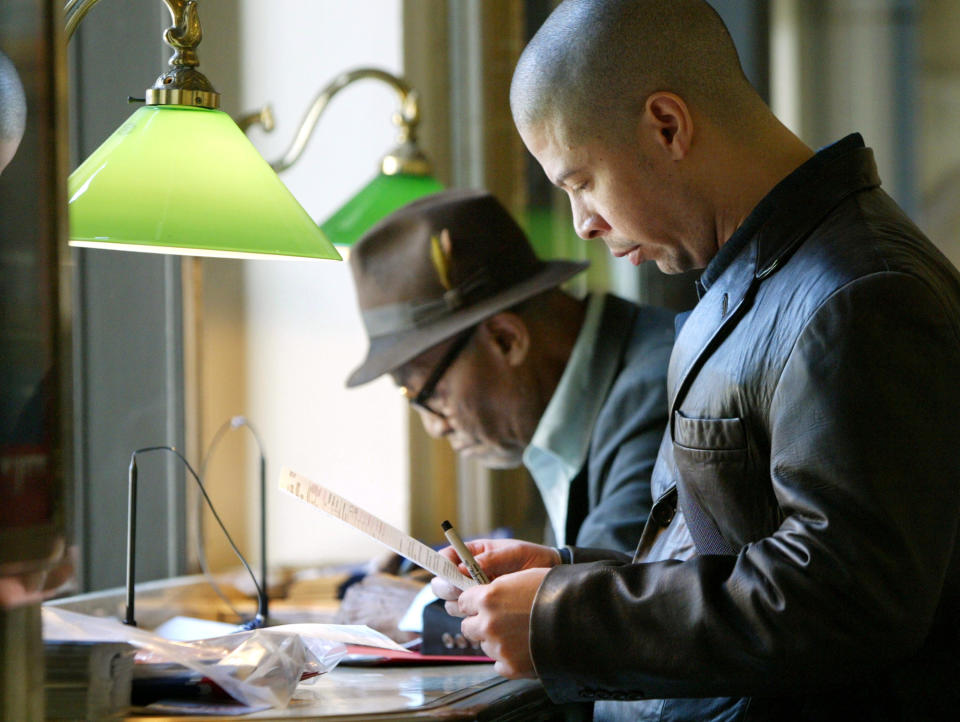 Ainsley Connell (R) does his last-minute taxes at the James A. Farley post office in New York City. The Internal Revenue Service is expecting nearly 160 million taxpayers to file this tax season. (Credit: Monika Graff, Getty Images)