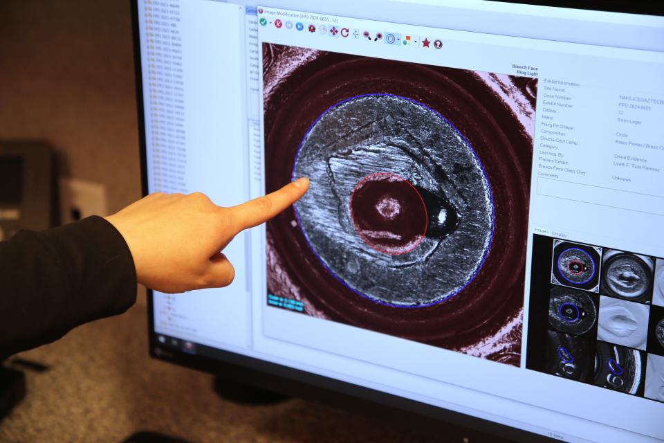 Crime scene investigator Katie Mason of the San Juan County Sheriff's Office points out some of the elements she would look for in identifying a round fired from a particular gun while using the equipment inside a mobile ballistics lab on Monday, May 13, 2024.