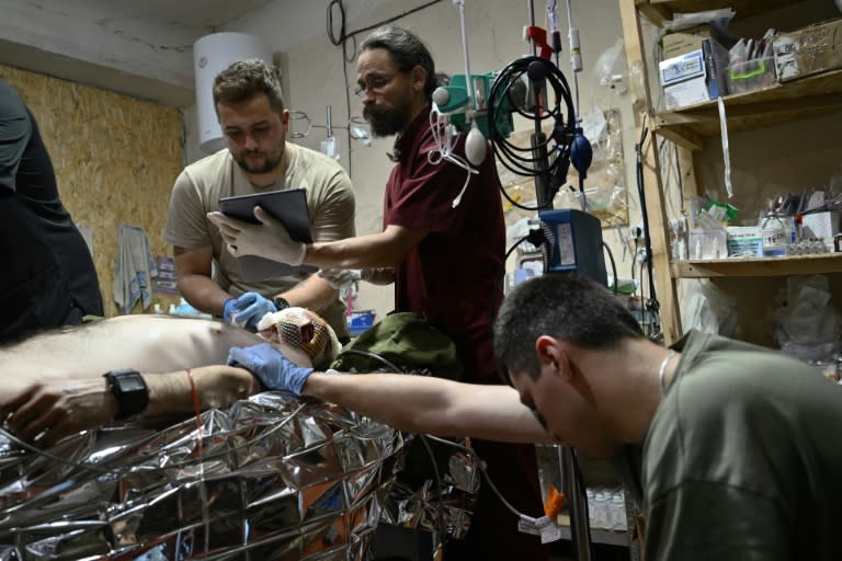 Des médecins militaires soignent un soldat ukrainien lourdement blessé à un point de stabilisation de la zone de Pokrovsk, dans la région de Donetsk, le 12 juin 2024 (Genya SAVILOV)