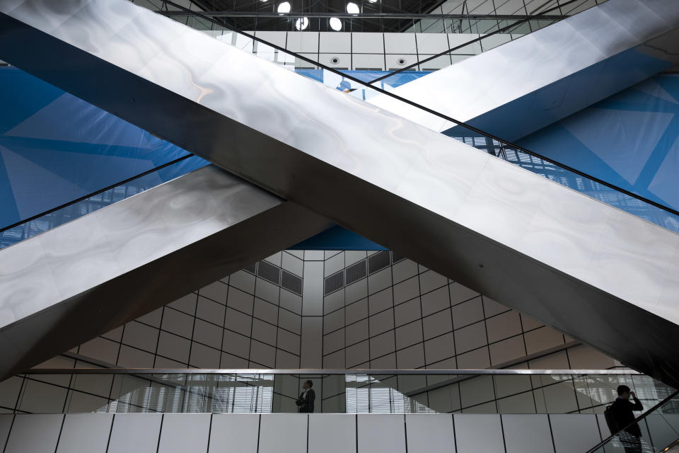 A man rides the escalator at the Suntec convention centre during the 33rd ASEAN summit in Singapore, Monday, Nov. 12, 2018. (AP Photo/Bernat Armangue)