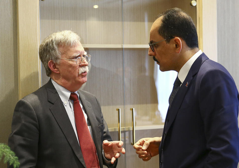 FILE - In this Jan. 8, 2019, file photo, U.S. national security adviser John Bolton, left, and his Turkish counterpart and senior adviser to President Recep Tayyip Erdogan, Ibrahim Kalin, right, talk at the Presidential Palace in Ankara, Turkey. In President Donald Trump’s Washington, matters of war and peace are decided in 280-character bursts. It’s up to John Bolton to massage them into a foreign policy. (Presidential Press Service via AP, Pool)