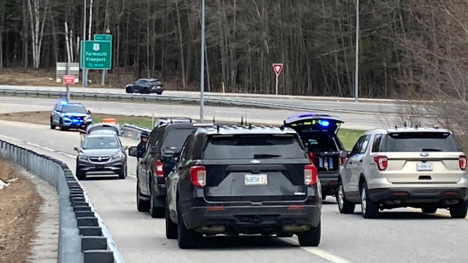 Vehicles are stopped on a highway at a scene where people were injured in a shooting on Interstate 295 in Yarmouth, Maine, Tuesday, April 18, 2023. Gunfire that erupted on the busy highway in Maine is linked to a second crime scene where people have been found dead in a home about 25 miles away in the town of Bowdoin, Maine, state police said Tuesday. (AP Photo/Patrick Whittle)
