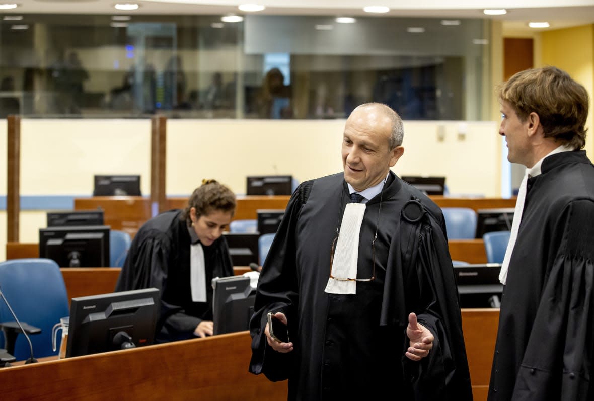 Felicien Kabuga’s defense lawyer Emmanuel Altit, left, speaks with prosecutor Rupert Elderkin in court at the UN International Residual Mechanism for Criminal Tribunals (IRMCT) in The Hague, Thursday, Sept. 29 2022. (Koen van Weel/Pool Photo via AP, file)