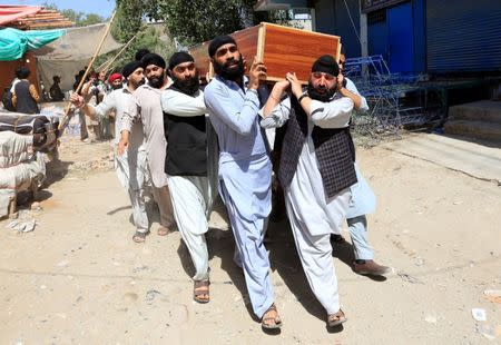 Afghan Sikh men carry the coffin of one of the victims of yesterday's blast in Jalalabad city, Afghanistan July 2, 2018. REUTERS/Parwiz