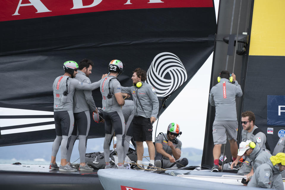 Italy's Luna Rossa team members celebrate after defeating Team New Zealand sail in race two of the America's Cup on Auckland's Waitemata Harbour, Wednesday, March 10, 2021. (Chris Cameron/Photosport via AP)