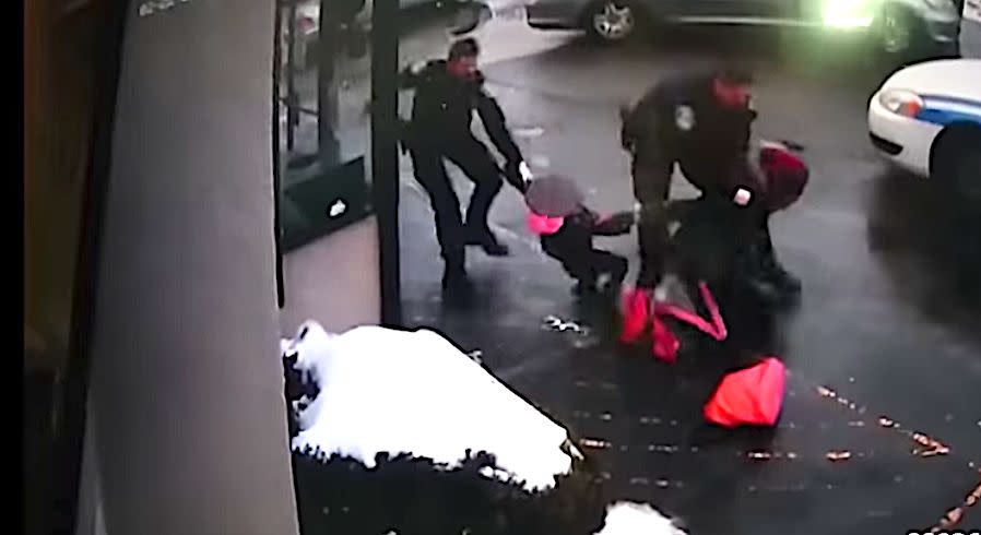 One officer can be seen tackling the woman while another tries to wrest away her 3-year-old daughter. (Photo: Screen Shot;/Police Body Cam Video/Rochester Police Department)