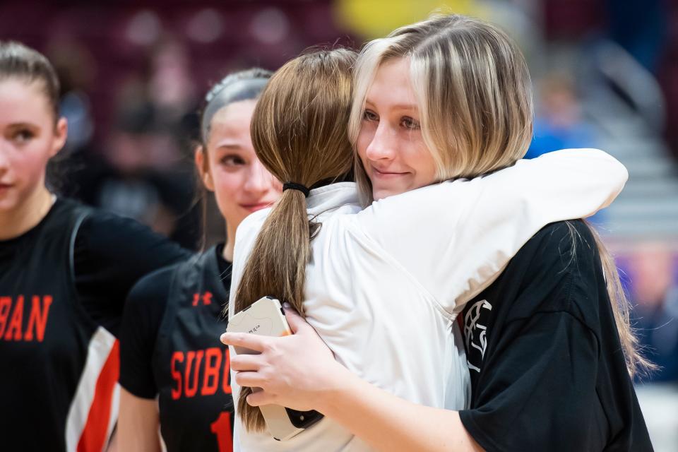 Injured York Suburban senior Alyssa Dougherty hugs head coach Jess Weaver after the Trojans fell in the District 3 Class 5A girls' basketball championship at the Giant Center on March 2, 2023, in Derry Township.
