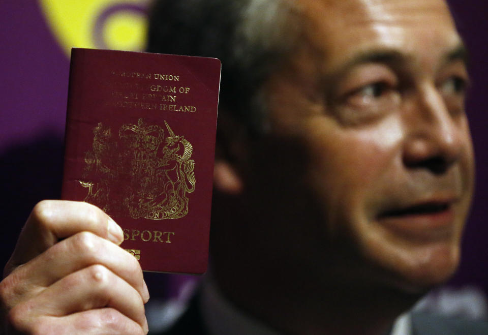 FILE - In this file photo dated Friday, June 3, 2016, UK Independence Party (UKIP) party leader Nigel Farage shows his British passport as he addresses media and party members before the upcoming EU referendum in London. Farage was a leading campaigner advocating Britain's Brexit split from Europe. After nearly five decades of economic and social integration, From the start of 2021 Britain will embark on a more-distant relationship with the European Union, and freedom of movement seems set to dramatically change for people wanting to cross the English Channel. (AP Photo/Frank Augstein, FILE)