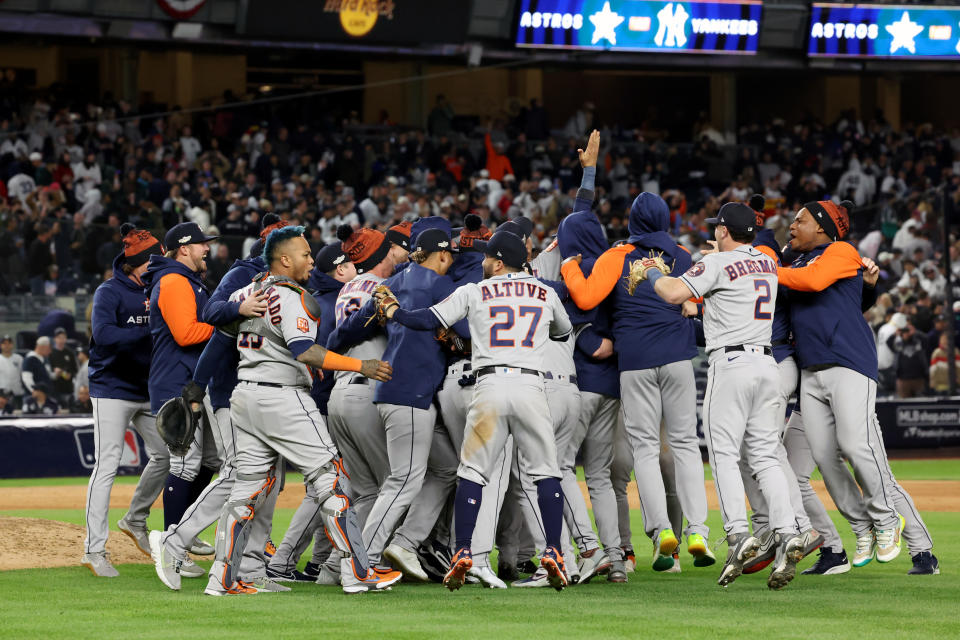 NEW YORK, NY - OCTOBER 23: Members of the Houston Astros celebrate with teammates on the field after the Astros defeated the New York Yankees in Game 4 of the ALCS at Yankee Stadium on Sunday, October 23, 2022 in New York, New York.  (Photo by Mary DeCicco/MLB Photos via Getty Images)