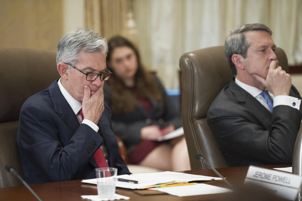 FILE- In this June 14, 2018, file photo, Federal Reserve Board Chairman Jerome Powell, left, and Vice Chair Randal Quarles listen during an open meeting in Washington. The Federal Reserve has given the OK to 32 of the 35 biggest banks in the U.S. to raise their dividends and buy back shares, judging their financial foundations sturdy enough to withstand a major economic downturn. (AP Photo/Cliff Owen, File)