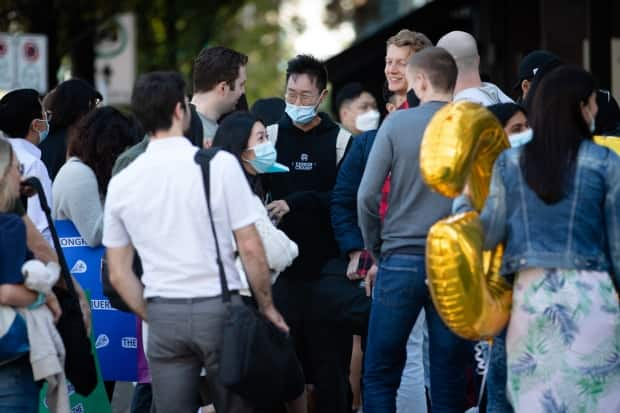 Accounting students wait outside of a restaurant while celebrating the end of their final exam in Vancouver, B.C., on Wednesday, Sept. 15, 2021.  (Maggie MacPherson/CBC - image credit)