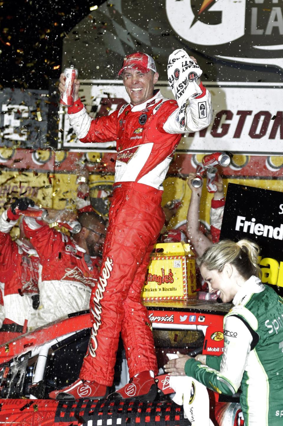 Kevin Harvick celebrates in Victory Lane after winning the NASCAR Sprint Cup auto race at Darlington Raceway in Darlington, S.C., Saturday, April 12, 2014. (AP Photo/Chuck Burton)