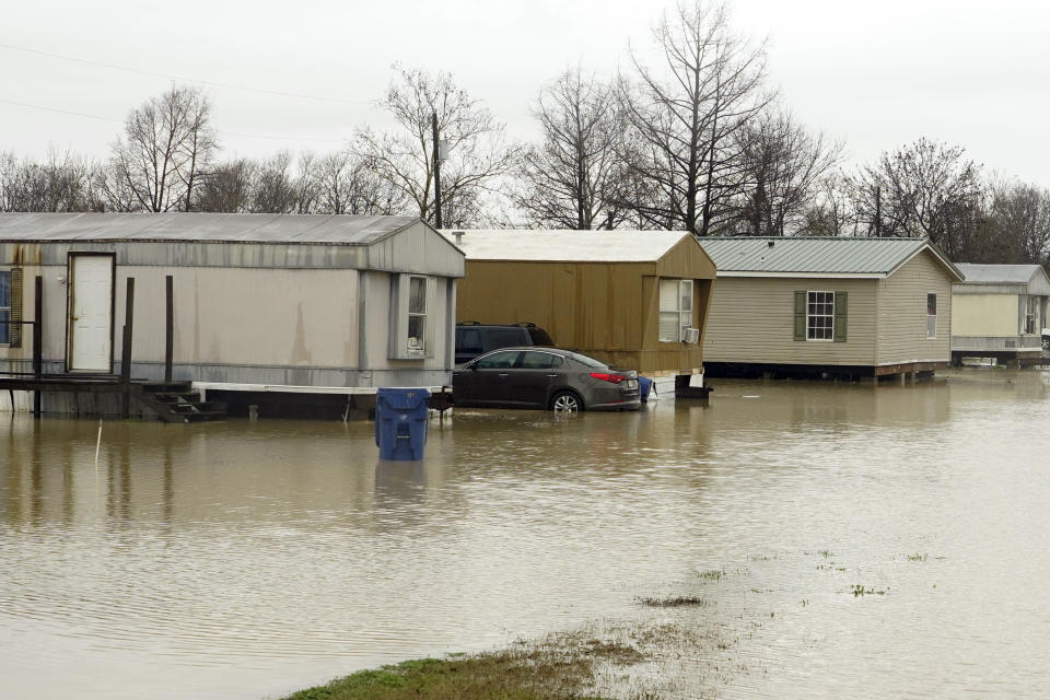 A mobile home community in Ruleville, Miss., is flooded from torrential rains that accompanied destructive storms that ripped across the U.S., spawning tornadoes that killed a young boy and his mother in Louisiana, smashed mobile homes and chicken houses in Mississippi and threatened neighboring Southern states with additional severe weather Wednesday, Dec. 14, 2022. (AP Photo/Rogelio V. Solis)