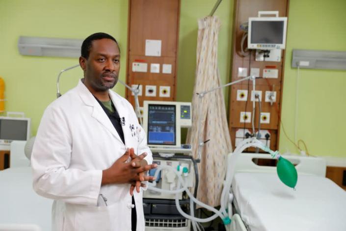 Dr. Martin Musumbi stands in front of a ventilator that was modified to be used simultaneously by two patients, to help fight the spread of the coronavirus disease (COVID-19) at the Aga Khan University Hospital in Nairobi