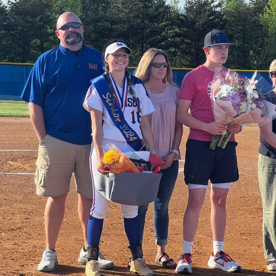 Madison High's Hailey Griffin has signed a letter of intent to play softball at Pfeiffer University. She's pictured here with her parents on senior night.