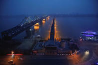 Lights are turned on on the Friendship and the Broken bridges over the Yalu River connecting the North Korean town of Sinuiju and Dandong in China's Liaoning province, March 30, 2017. REUTERS/Damir Sagolj