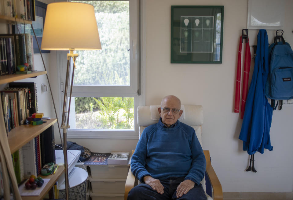 In this Friday, Jan. 17, 2020, photo, Holocaust survivor Maurice Gluck, poses for a photo in his home in Ya'ad, northern Israel. Shortly before they were rounded up by Nazi troops in Belgium and deported to Auschwitz in 1942, the parents of three-year-old Maurice Gluck placed their only child in the care of a local Christian family. Gluck forgot his Yiddish mother tongue and that he even had parents of his own. (AP Photo/Ariel Schalit)