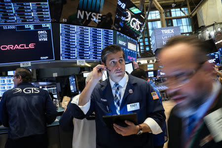 FILE PHOTO: Traders work on the floor at the New York Stock Exchange (NYSE) in New York, U.S., April 8, 2019. REUTERS/Brendan McDermid