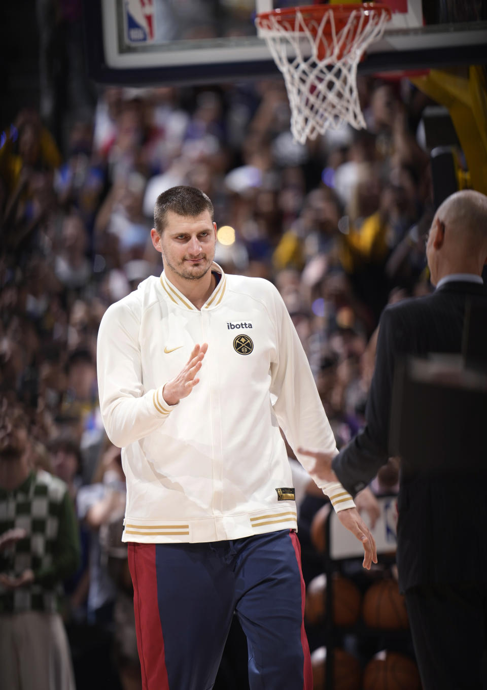 Denver Nuggets center Nikola Jokic greets NBA Commissioner Adam Silver before the team's NBA basketball game against the Los Angeles Lakers on Tuesday, Oct. 24, 2023, in Denver. (AP Photo/David Zalubowski)