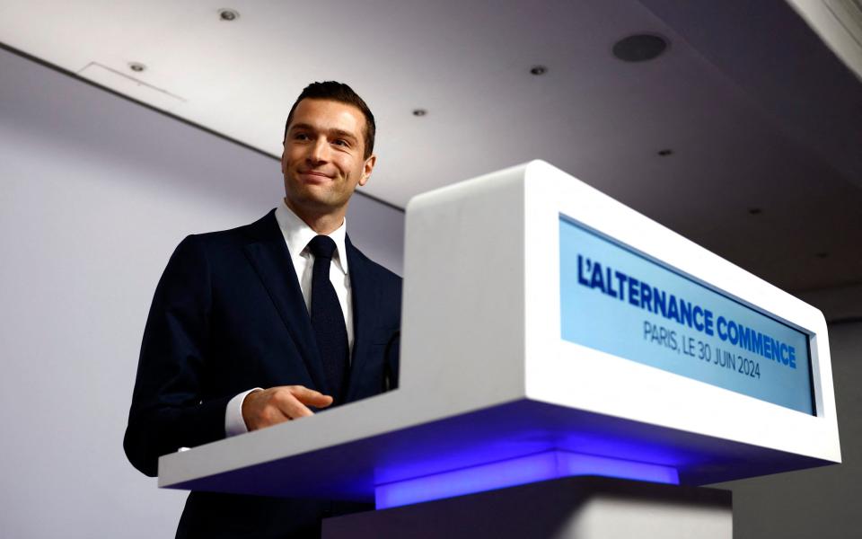 Jordan Bardella reacts on stage after partial results in the first round of the early French parliamentary elections