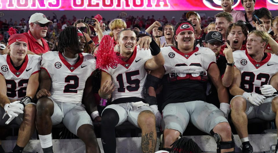 Georgia quarterback Carson Beck (15) celebrates with teammates and fans after defeating Florida in an NCAA college football game, Saturday, Oct. 28, 2023, in Jacksonville, Fla. (AP Photo/John Raoux)
