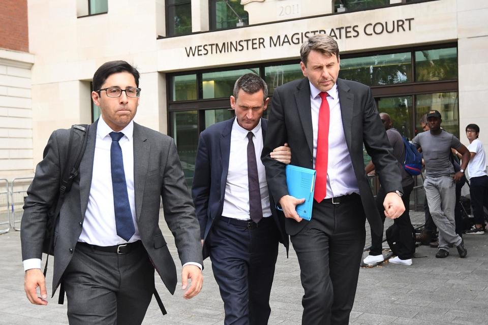 Lord Holmes of Richmond (centre) leaves Westminster Magistrates' Court last year (PA)