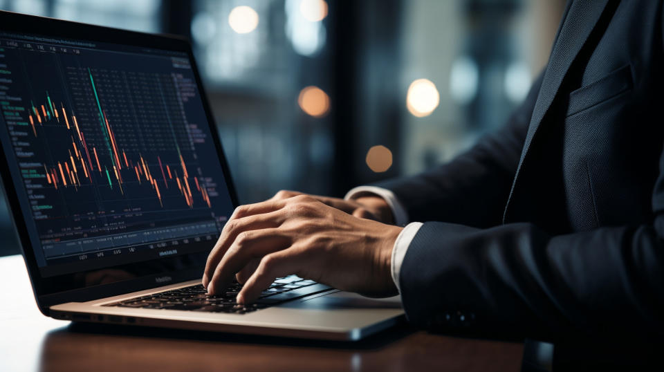 A close-up of a portfolio manager's face with a laptop nearby, highlighting their expertise in investment management.