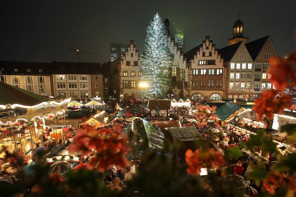 FRANKFURT, GERMANY - NOVEMBER 26: The annual Christmas market is illuminated in the city center on its opening day on November 26, 2012 in Frankfurt, Germany. Christmas markets, with their stalls selling mulled wine, Christmas tree decorations and other delights, are an integral part of German Christmas tradition, and many of them opened across Germany today. (Photo by Hannelore Foerster/Getty Images)