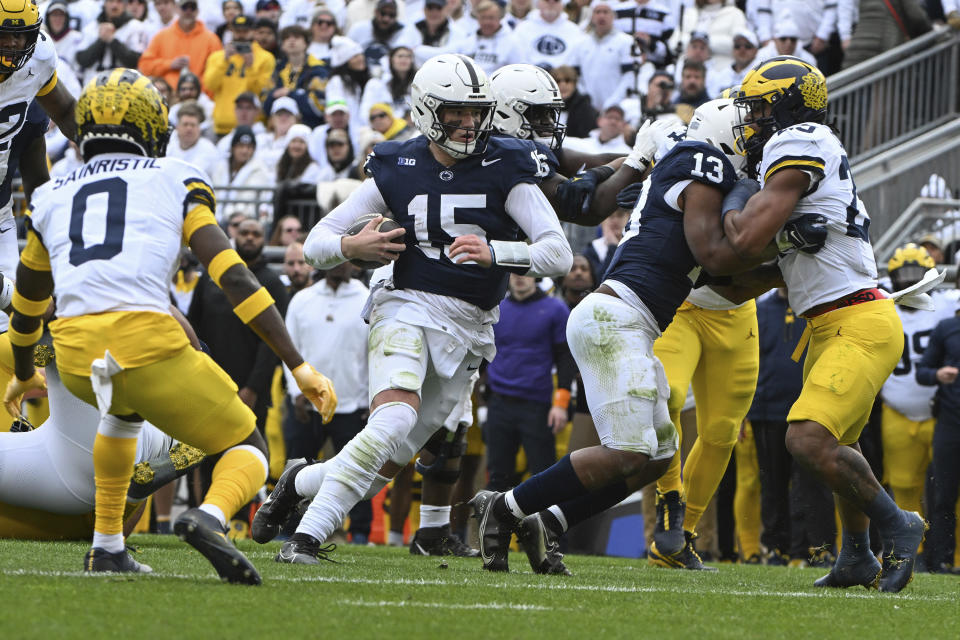 Penn State quarterback Drew Allar (15) scores a touchdown against Michigan during the first half of an NCAA college football game, Saturday, Nov. 11, 2023, in State College, Pa. (AP Photo/Barry Reeger)