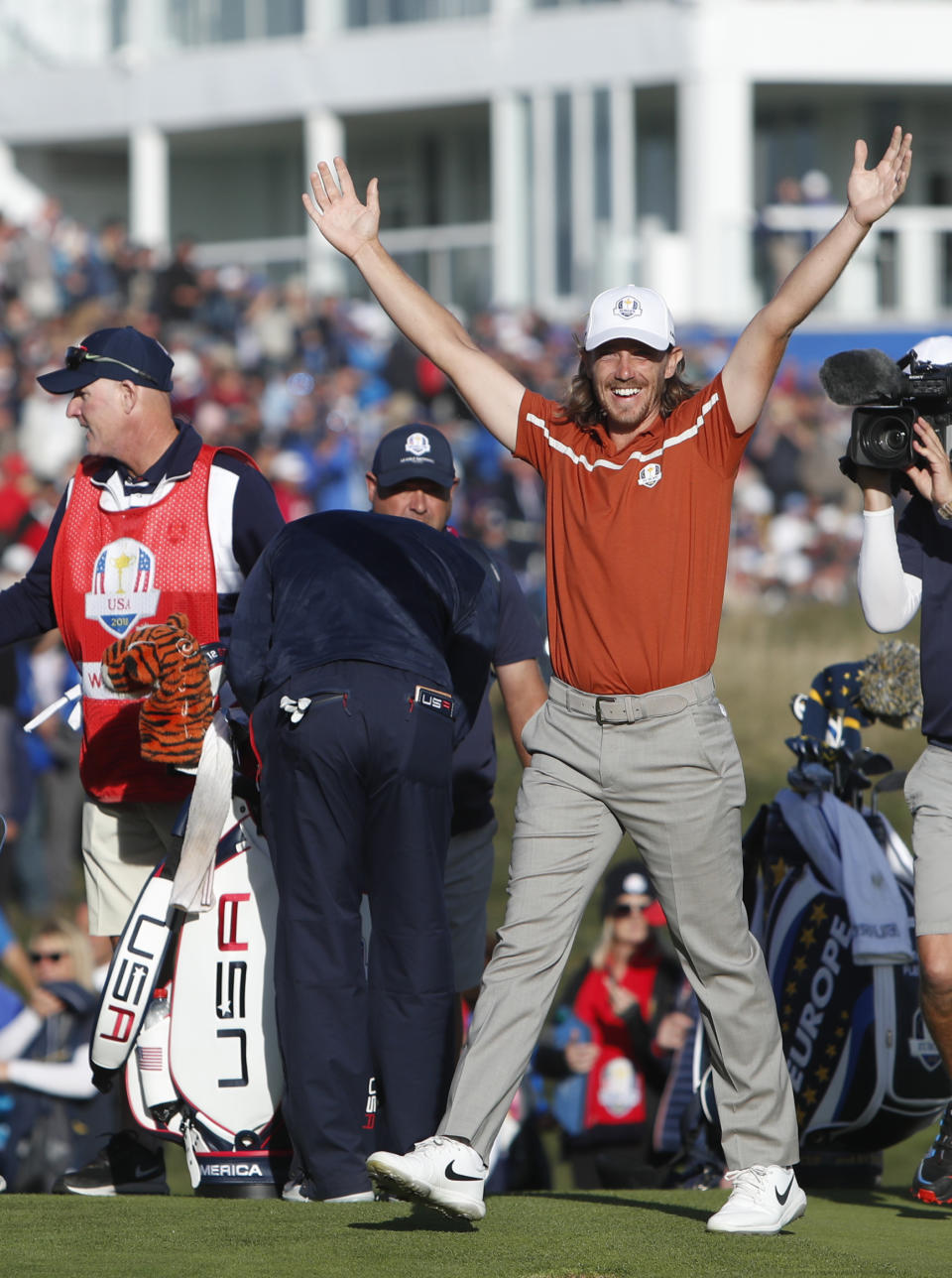 Europe's Tommy Fleetwood, right, celebrates next to Tiger Woods of the US after winning a foursome match on the second day of the 42nd Ryder Cup at Le Golf National in Saint-Quentin-en-Yvelines, outside Paris, France, Saturday, Sept. 29, 2018. Europe's Francesco Molinari and Tommy Fleetwood beat Tiger Woods of the US and Bryson Dechambeau of the US 5 and 4. (AP Photo/Alastair Grant)