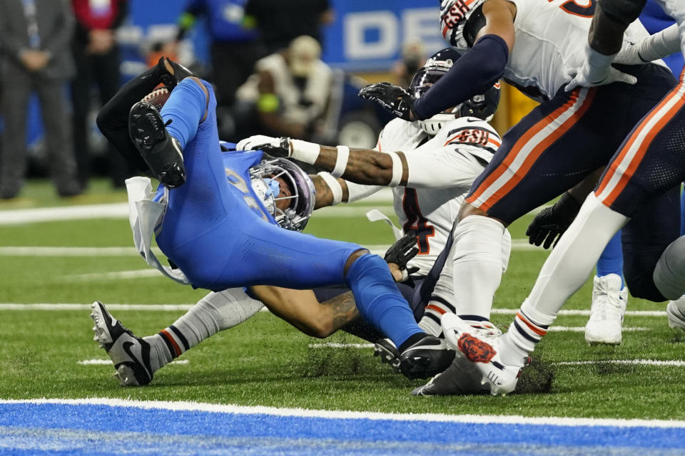 Detroit Lions running back Jahmyr Gibbs (26) is tackled by Chicago Bears safety Eddie Jackson (4) during the second half of an NFL football game, Sunday, Nov. 19, 2023, in Detroit. (AP Photo/Paul Sancya)