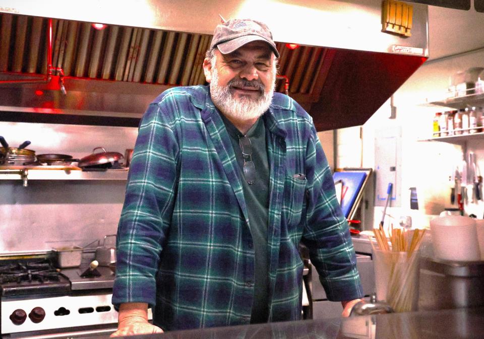 Old Mill Eatery & Smokehouse owner Fernando Perez poses in his kitchen at 4132 Shasta Dam Blvd. in Shasta Lake.