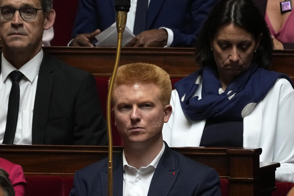 Hard-left newly elected parliament member Adrien Quatennens sits at the National Assembly, Tuesday, June 28, 2022 in Paris. France's National Assembly convenes for the first time since President Emmanuel Macron lost his parliamentary majority. (AP Photo/Michel Euler)