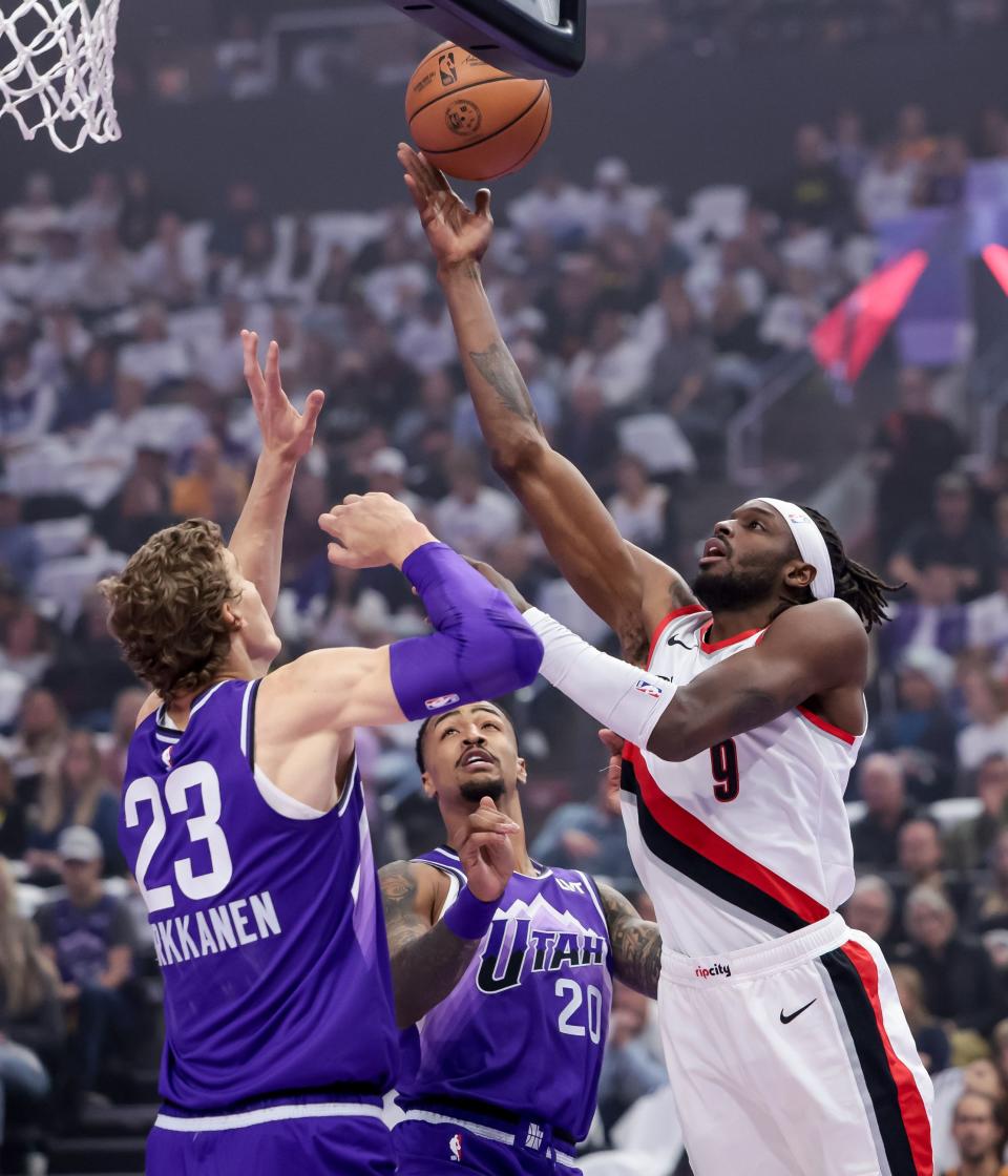 Portland Trail Blazers forward <a class="link " href="https://sports.yahoo.com/nba/players/5350" data-i13n="sec:content-canvas;subsec:anchor_text;elm:context_link" data-ylk="slk:Jerami Grant;sec:content-canvas;subsec:anchor_text;elm:context_link;itc:0">Jerami Grant</a> (9) goes to the hoop against Utah Jazz forward Lauri Markkanen (23) and forward John Collins (20) during the game at the Delta Center in Salt Lake City on Tuesday, Nov. 14, 2023. | Spenser Heaps, Deseret News