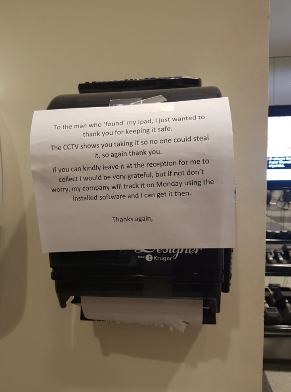 Note left on a paper towel dispenser thanking someone for finding an iPad and asking for it to be returned to reception. Mentions CCTV footage and recovery plan