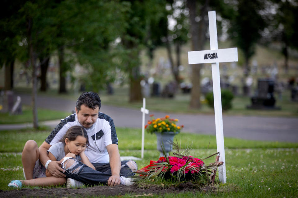 Juan Duran and his daughter Aurora, 7, spent some quiet time at the gravesite of his wife Aurora Chacon Esparza, who died at the age of 35 of Covid in Osseo, Minneapolis.