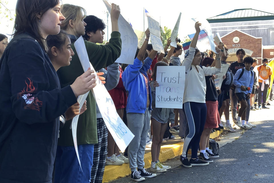 Students at McLean High School in McLean, Va., walk out of classes Tuesday, Sept. 27, 2022. Student activists held school walkouts across Virginia on Tuesday to protest Republican Gov. Glenn Youngkin's proposed changes to the state's guidance on district policies for transgender students that would roll back some accommodations. (AP Photo/Matthew Barakat)