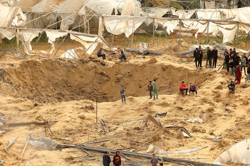 People stand around craters caused by Israeli bombardment in Rafah in the southern Gaza Strip on February 12. Photo by Ismael Mohamad/UPI